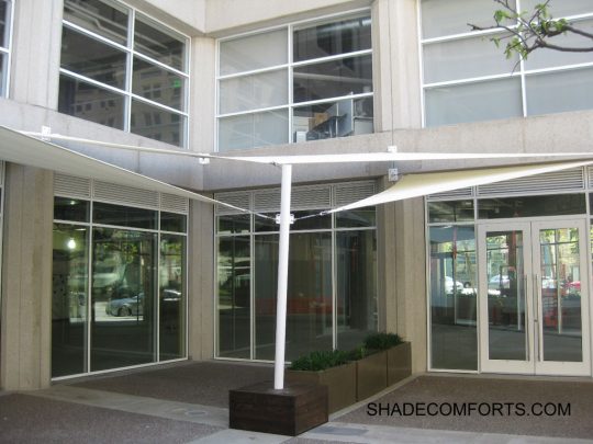 These fabric shade sails cover the front entrance to a San Francisco retail and office building. We secured wall plates to the concrete building with mechanical anchors.