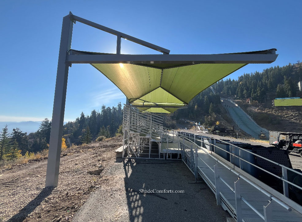 Bleacher shade structure covers spectators at Utah athletic field.